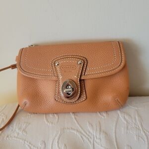 Coach Legacy Light Orange Pebbled Leather Wristlet Clutch with Turn-Lock.
